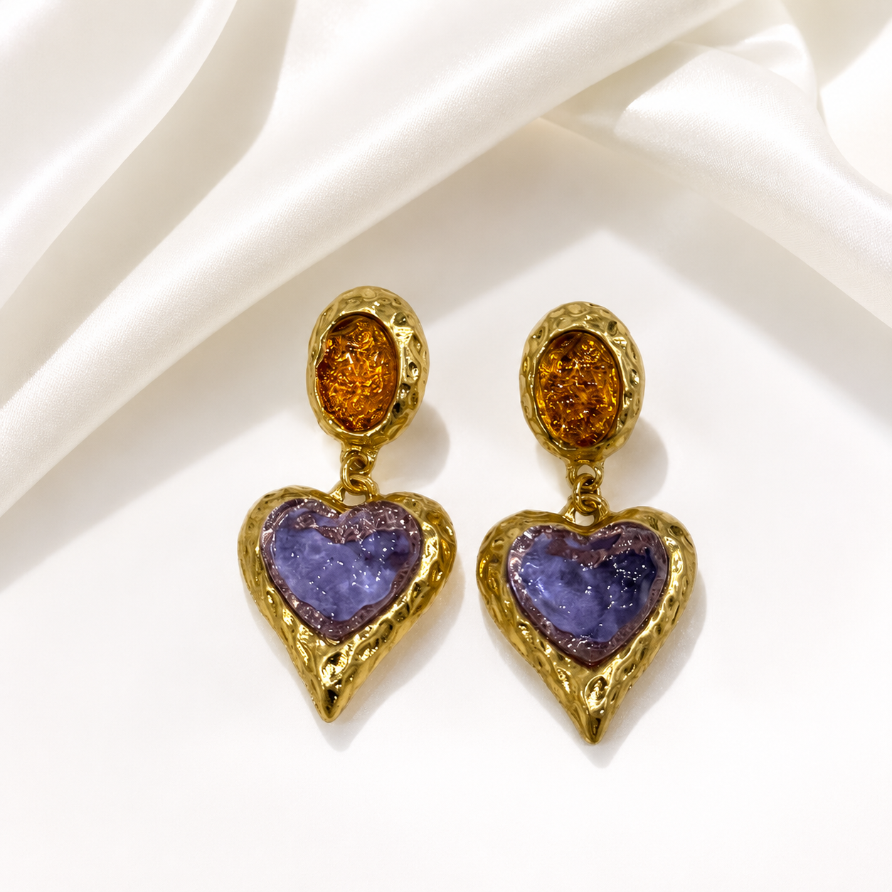 Light purple glass heart drop earrings with a gold-tone setting.