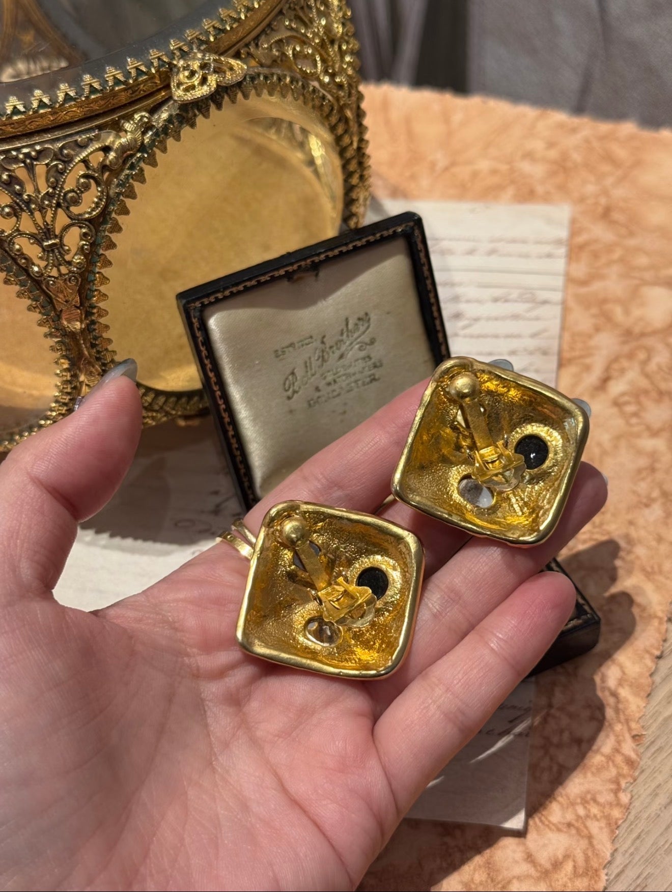 Back view of gold-tone square clip-on statement earrings with clip closure