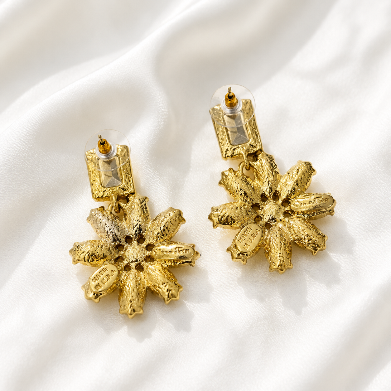 Back view of champagne crystal-style flower statement earrings showing post backs