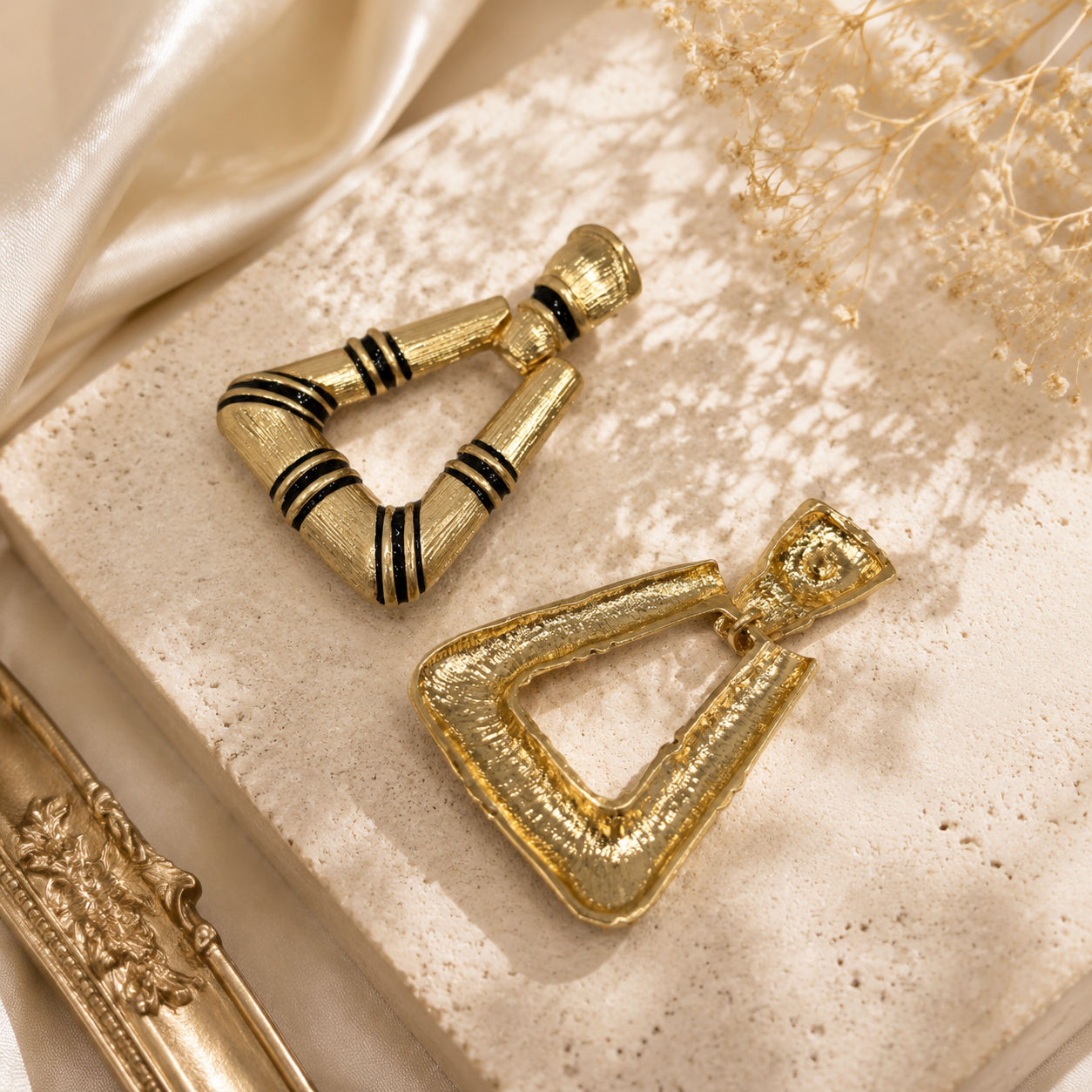 Gold-tone triangle stud earring with black enamel-style stripe accents, front and back view