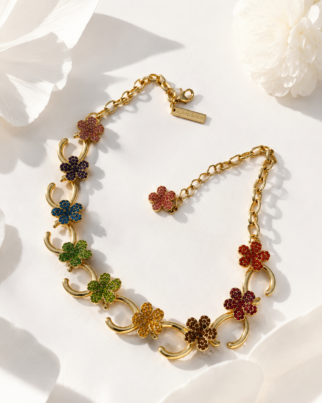 Gold-tone necklace with multicolor floral rhinestone-style accents angled view