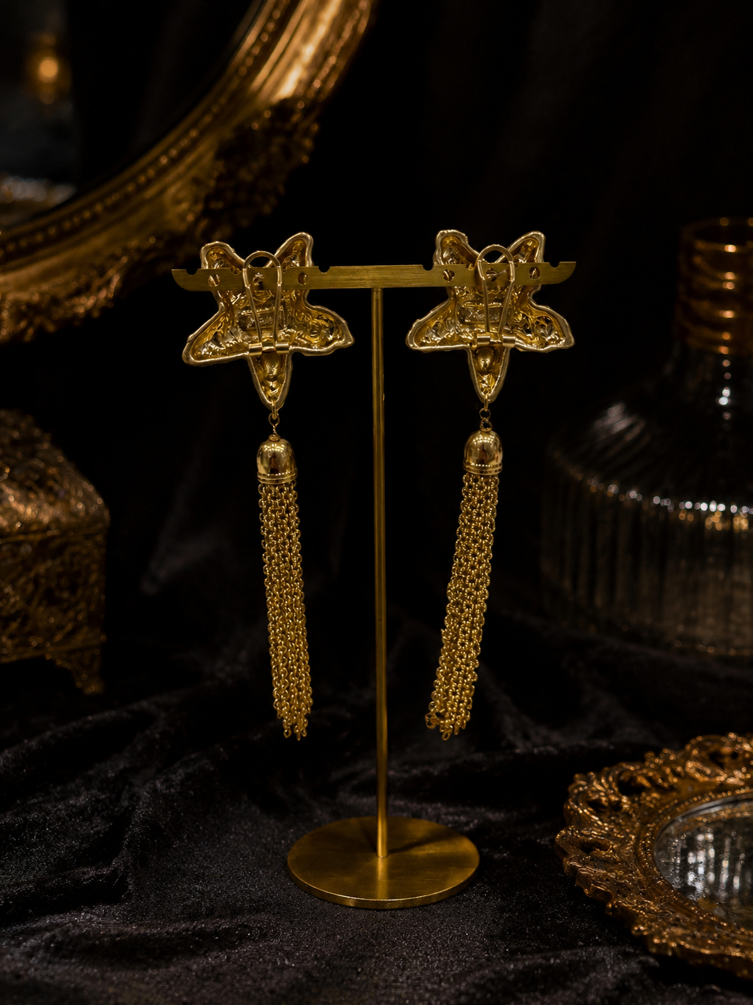Back view of gold-tone star chain tassel statement earrings