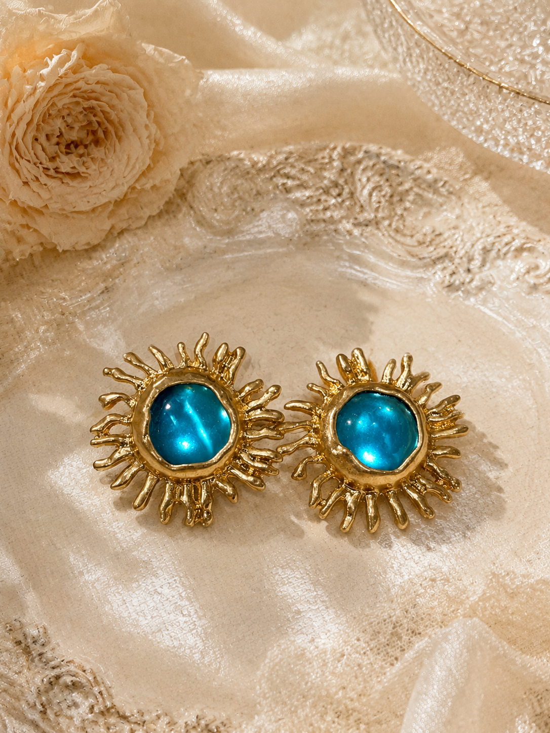 Gold-tone light blue sunflower glass-style stud earrings