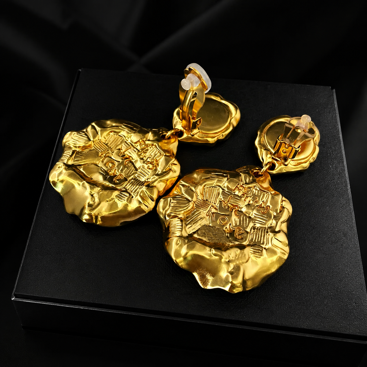 Gold-tone textured medallion clip-on earrings back view showing clip-on hardware
