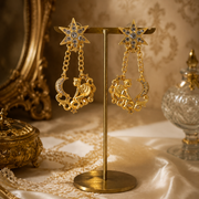 18K gold-plated celestial angel clip-on earrings with star and moon drops on display