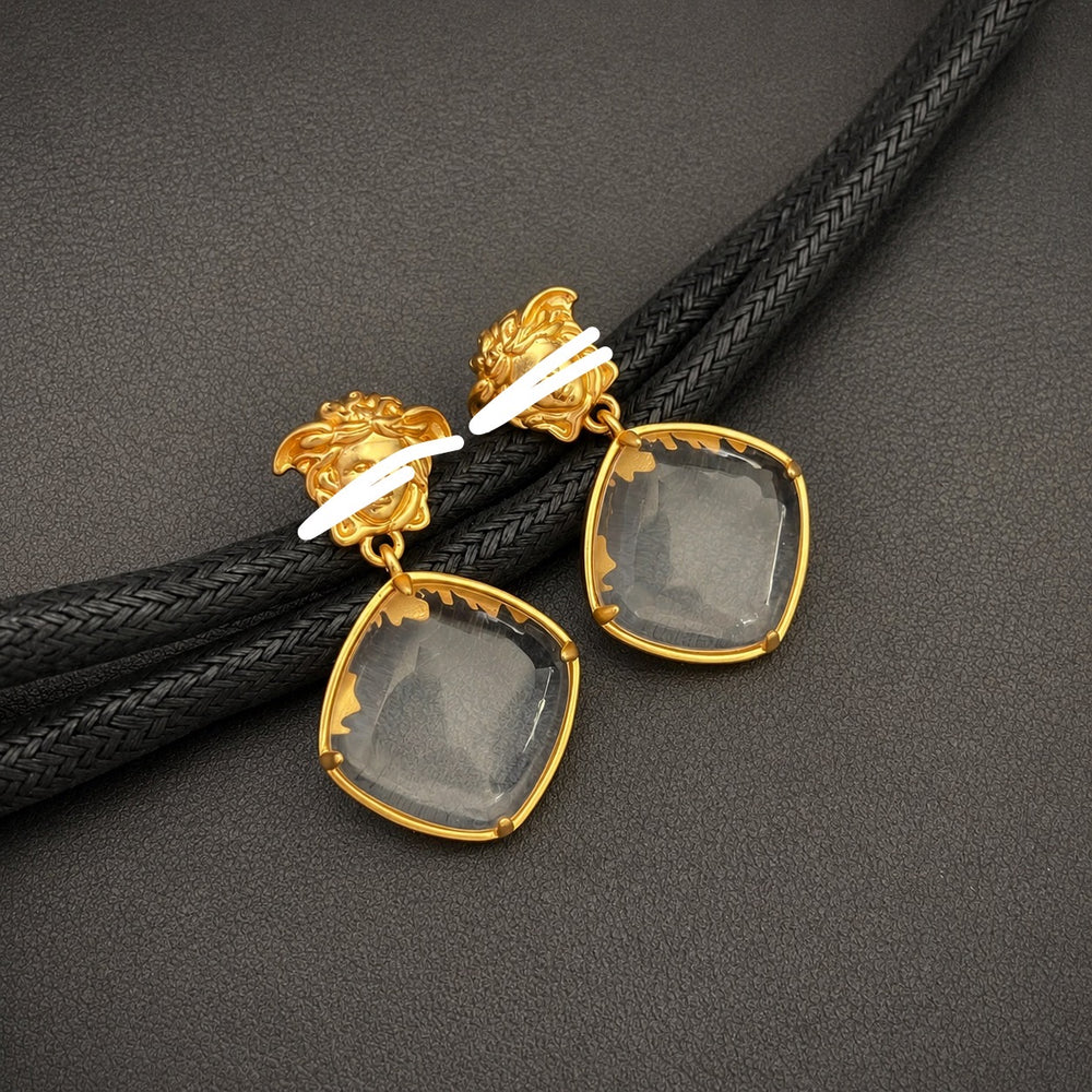 Front view of 18K gold-plated clear crystal-style drop earrings