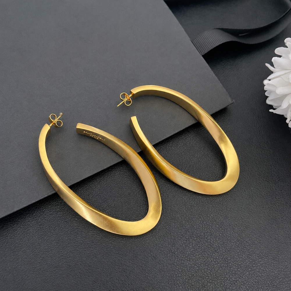 Styled view of 18K gold-plated vintage-inspired sculptural long stud earrings