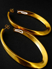 Close-up of 18K gold-plated vintage-inspired sculptural long stud earrings