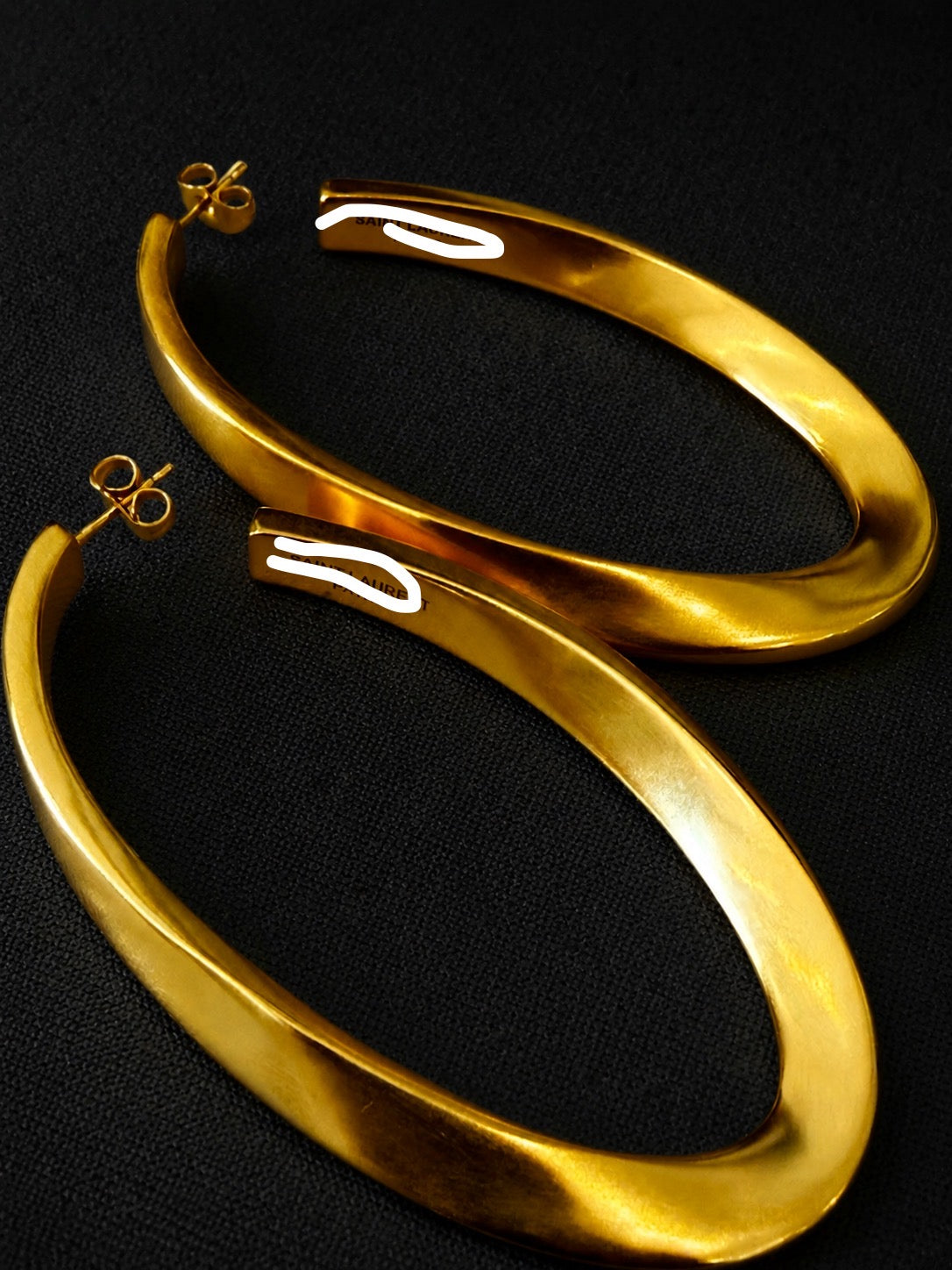 Close-up of 18K gold-plated vintage-inspired sculptural long stud earrings