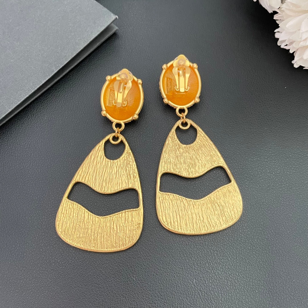 Back view of gold-tone textured openwork drop clip-on earrings