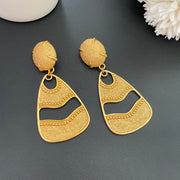 Front detail of 18K gold-plated textured openwork drop clip-on earrings