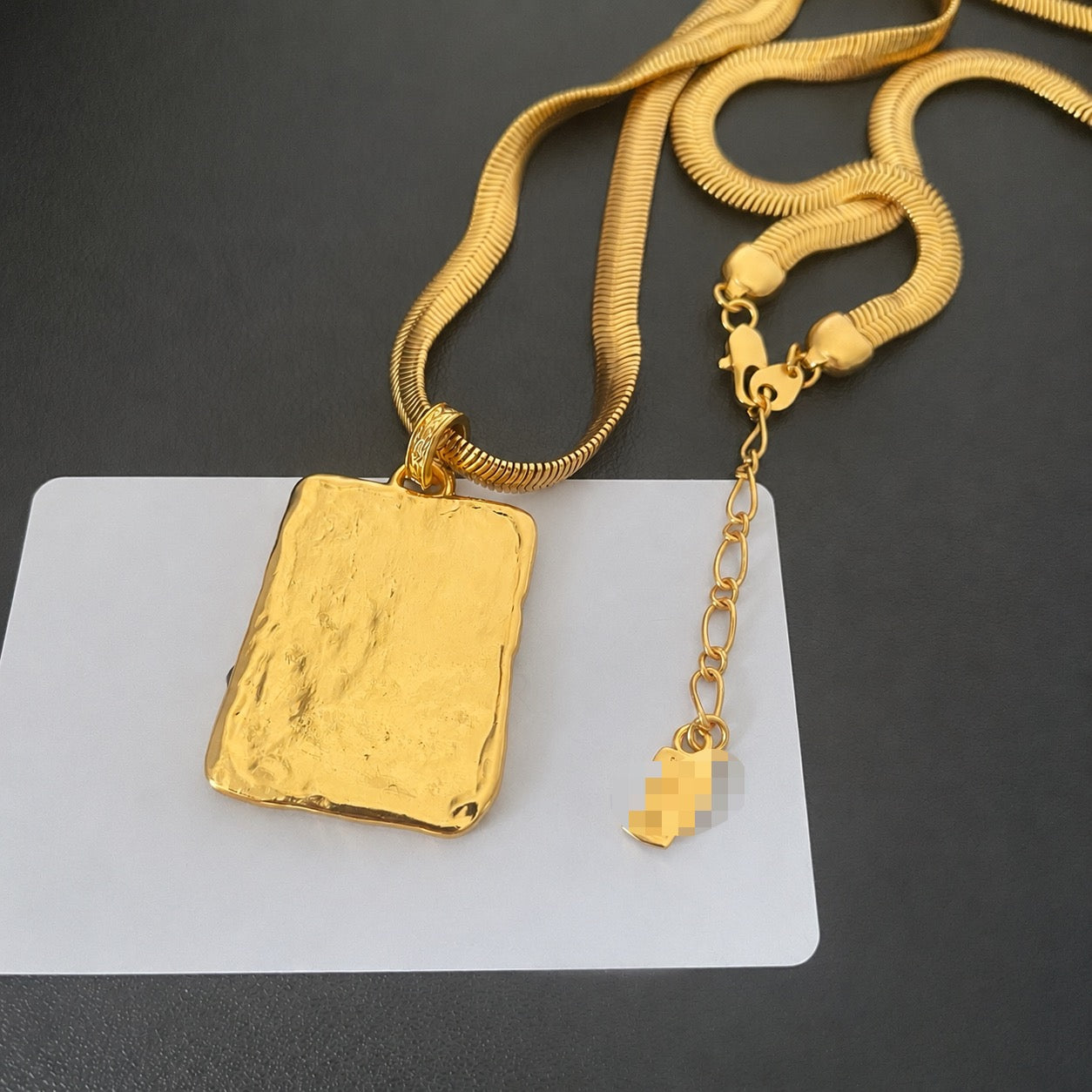 18K gold-plated vintage-inspired letter plaque pendant necklace showing the reverse side and extension chain