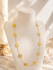18K gold-tone double-sided coin necklace set on display