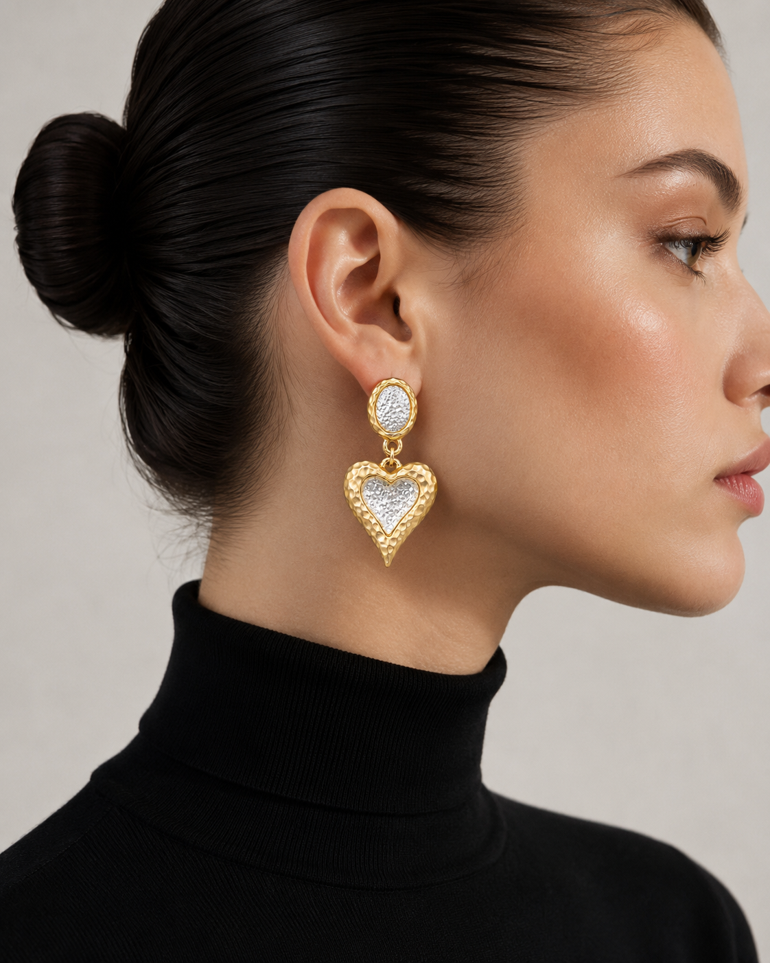 Gold-tone heart clip-on drop earrings with silver-tone centers detail view