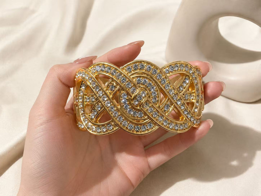 Gold-tone crystal-style interwoven ribbon statement cuff bracelet close-up