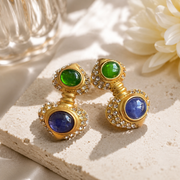 Gold-tone clip-on drop earrings with green and smoky gray accents
