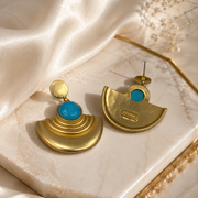 Front and back view of gold-tone fan-shaped turquoise-style stud earrings