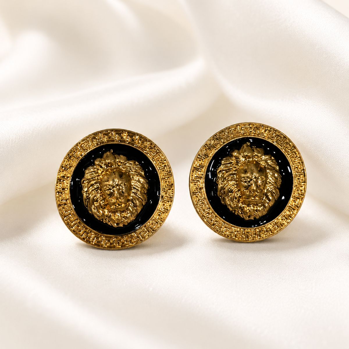 Pair of gold-tone lion enamel-style stud earrings with black circular centers