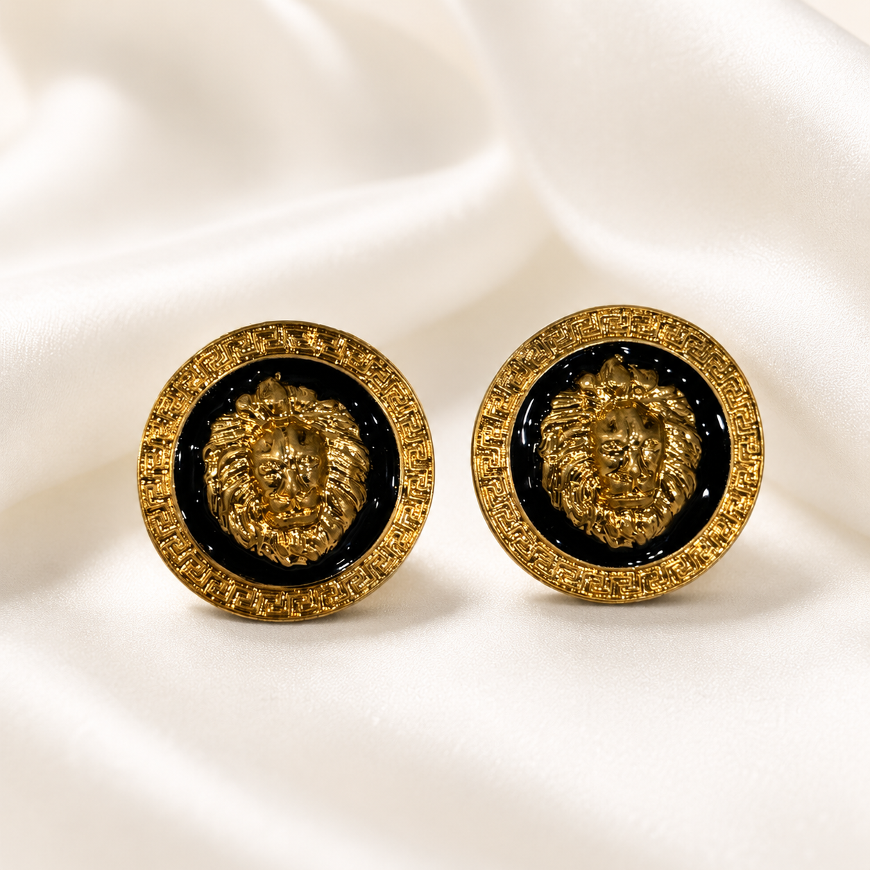 Pair of gold-tone lion enamel-style stud earrings with black circular centers