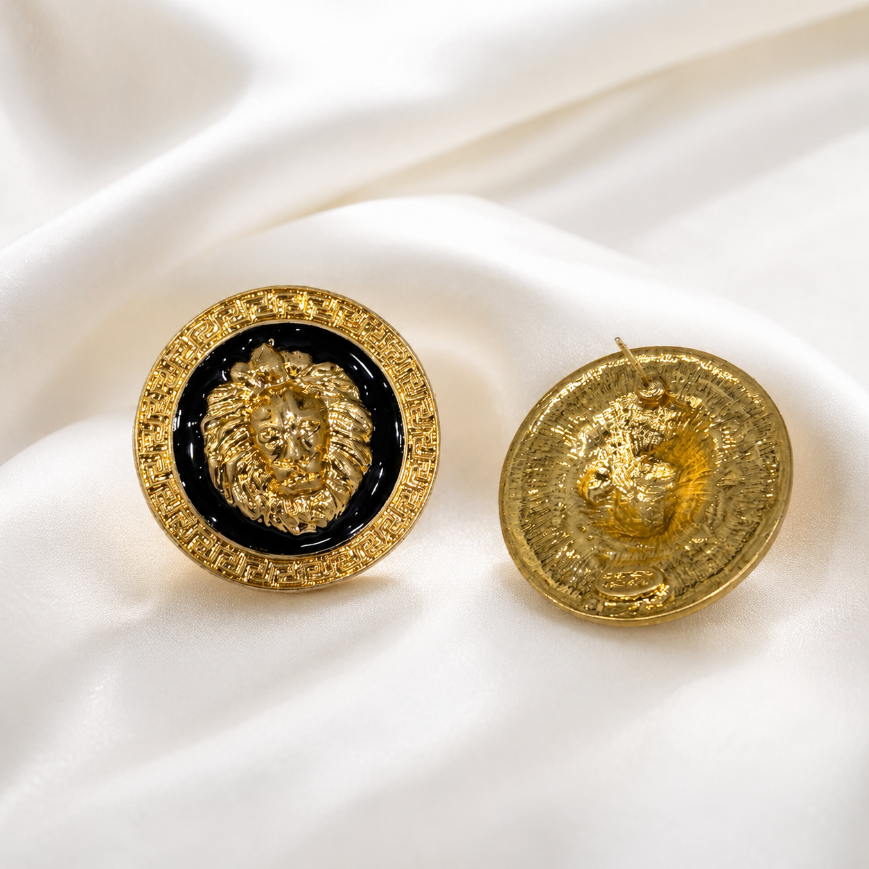 Front and back view of gold-tone lion enamel-style stud earrings