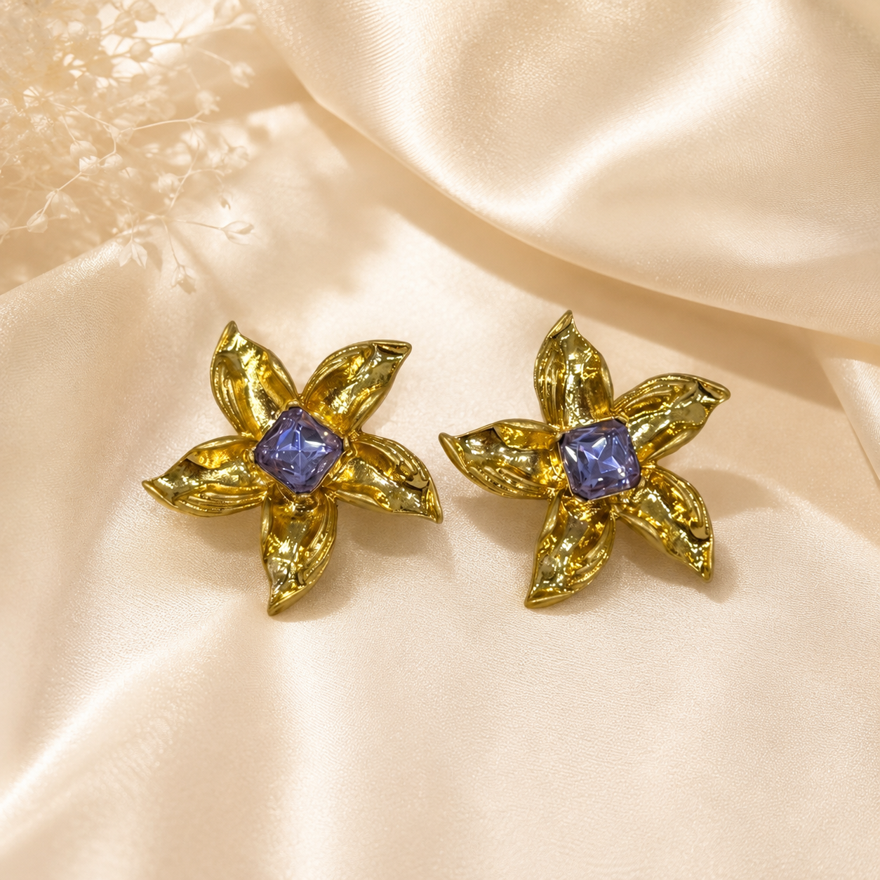 Purple gold-tone floral stud earrings with square crystal-style centers