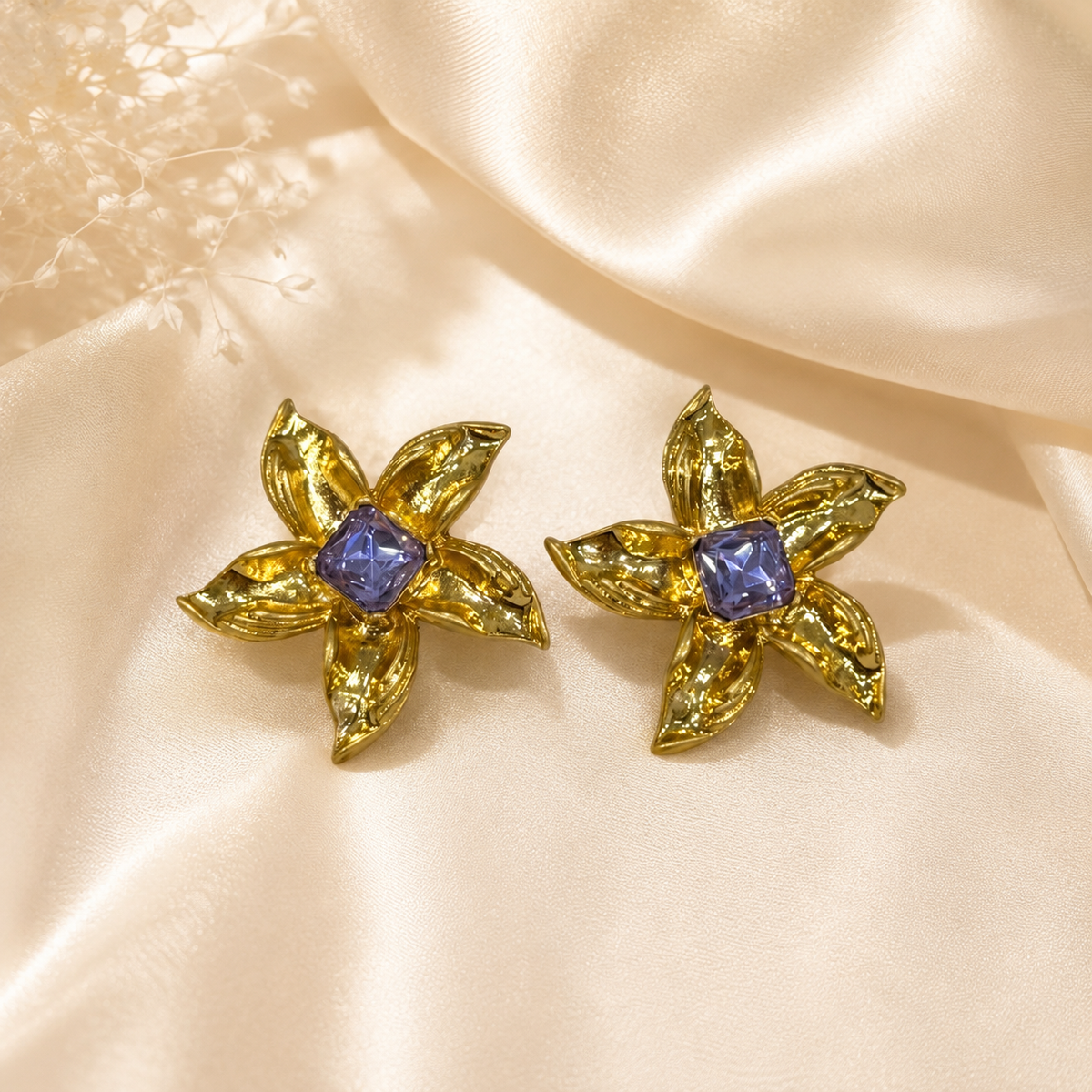 Purple gold-tone floral stud earrings with square crystal-style centers