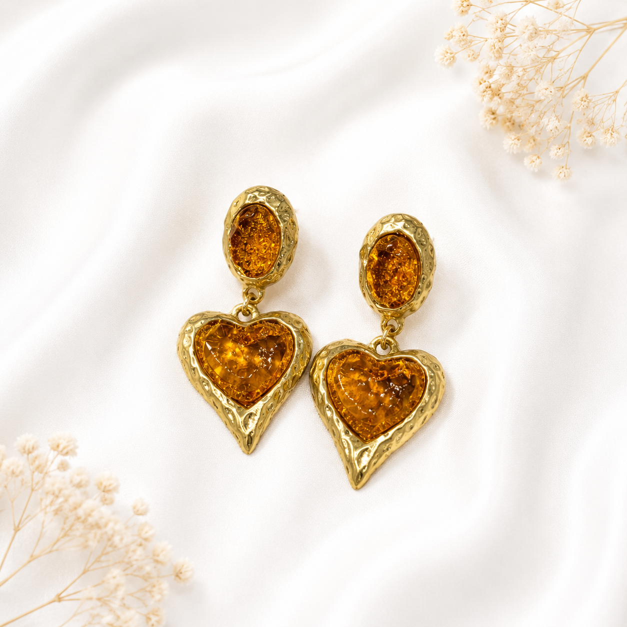Orange glass heart drop earrings with a gold-tone setting.