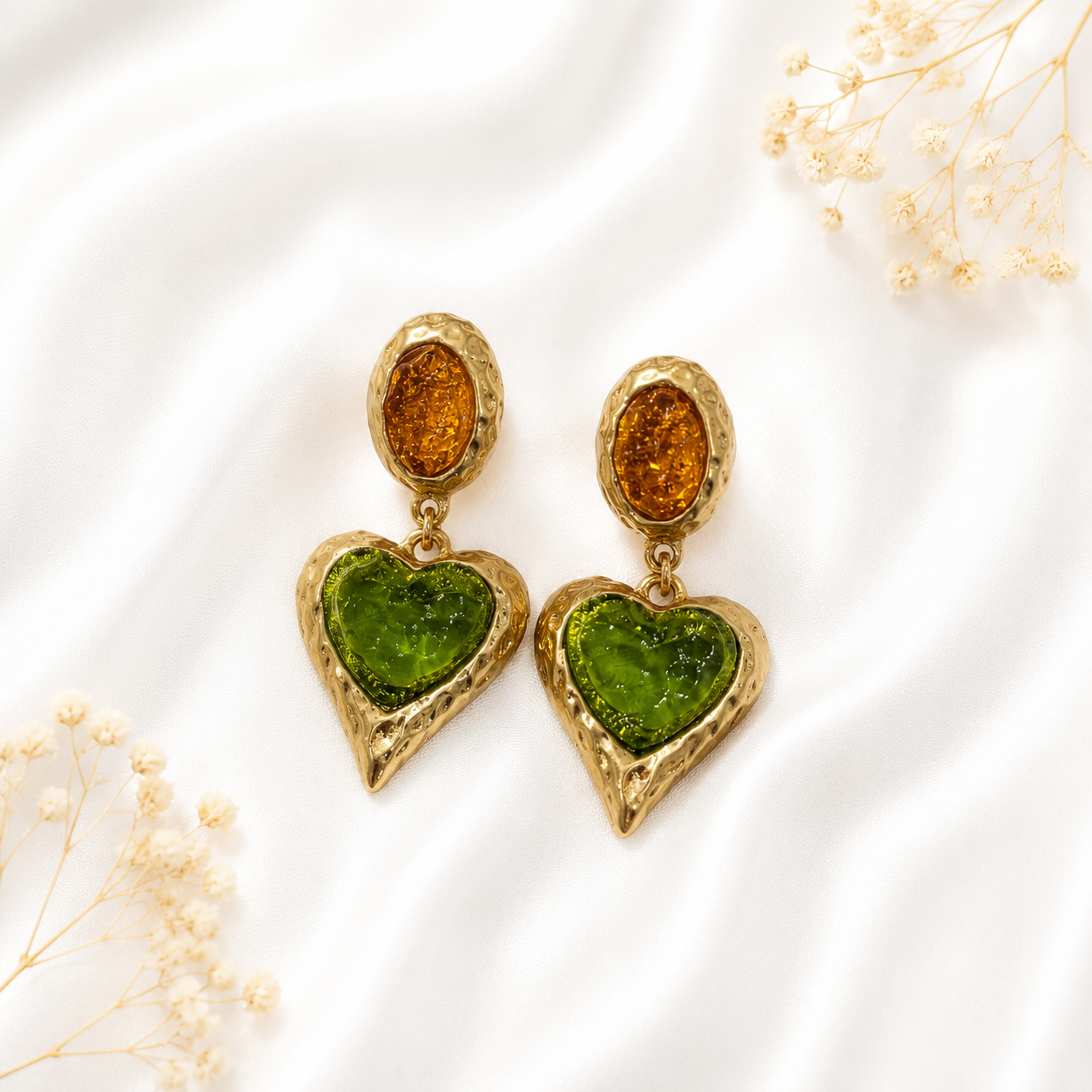 Light green glass heart drop earrings with a gold-tone setting.