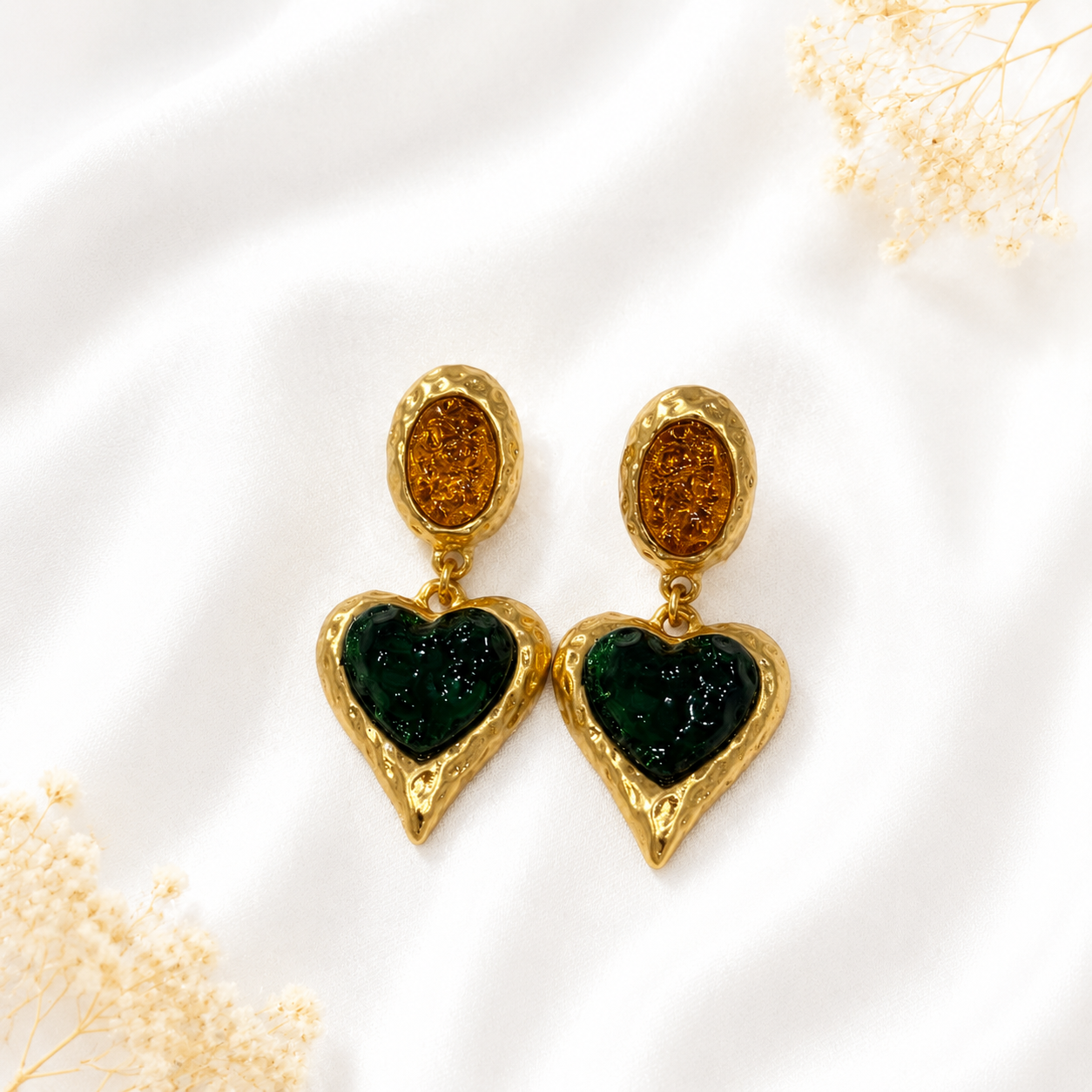 Dark green glass heart stud earrings with a gold-tone setting.