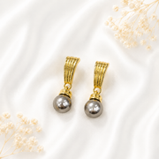 Gray pearl drop stud earrings with a gold-tone finish.