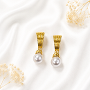 White pearl drop stud earrings with a gold-tone finish.
