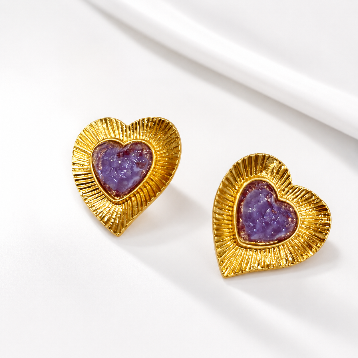 Light purple heart glass stud earrings with a gold-tone setting