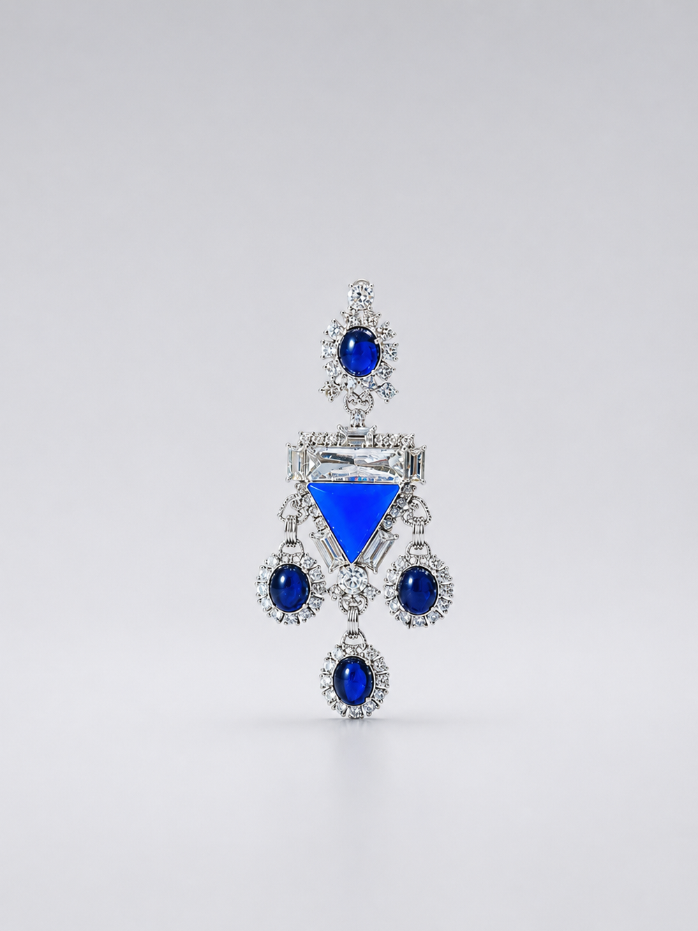 Silver-tone chandelier statement earrings with deep blue stone-style accents and clear crystal-style details