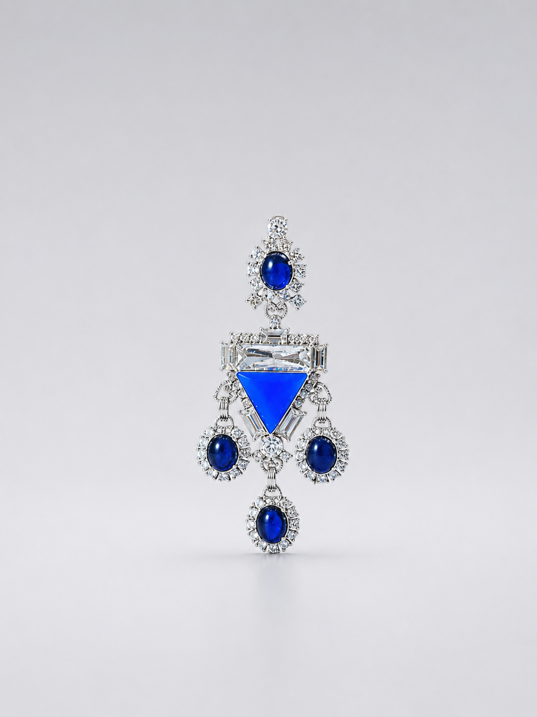 Silver-tone chandelier statement earrings with deep blue stone-style accents and clear crystal-style details
