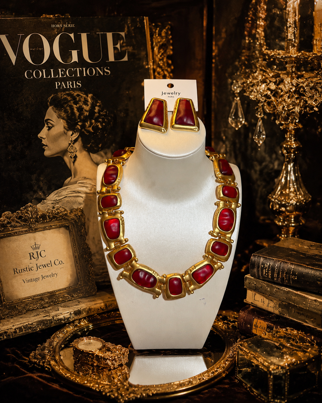 Gold-tone red stone-style necklace and stud earrings set displayed on jewelry bust
