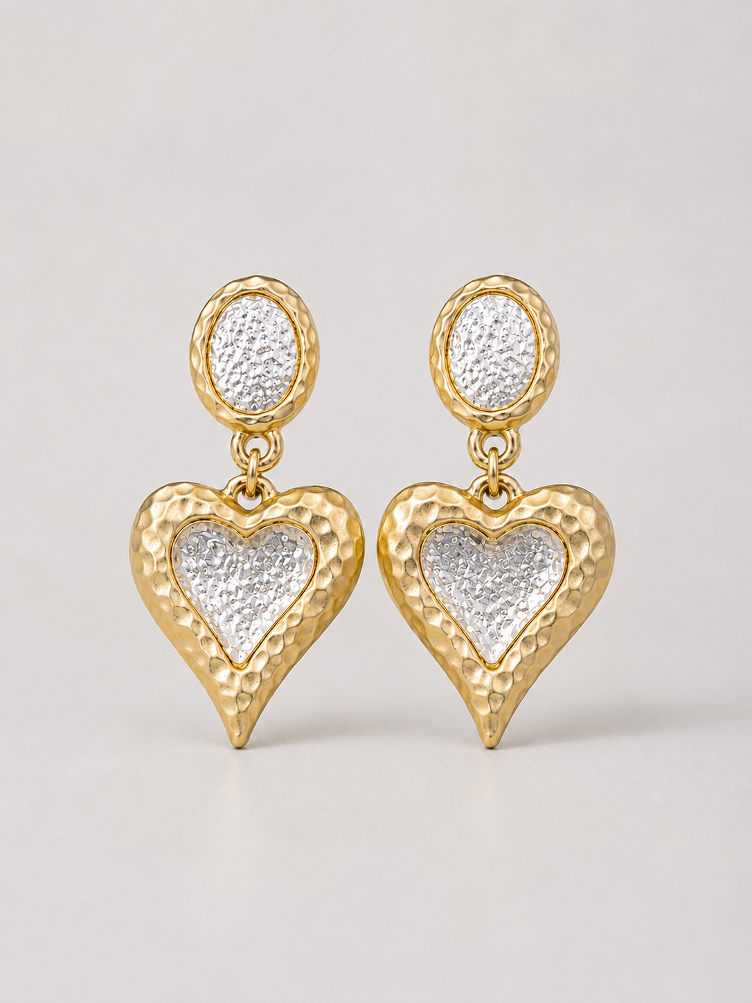 Gold-tone heart clip-on drop earrings with silver-tone centers front view
