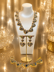 Gold-tone multicolor crystal-style heart necklace bracelet and earrings set displayed together