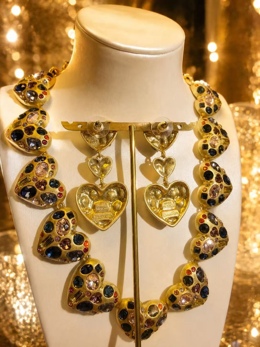 Gold-tone multicolor heart necklace and earrings set detail view with crystal-style accents