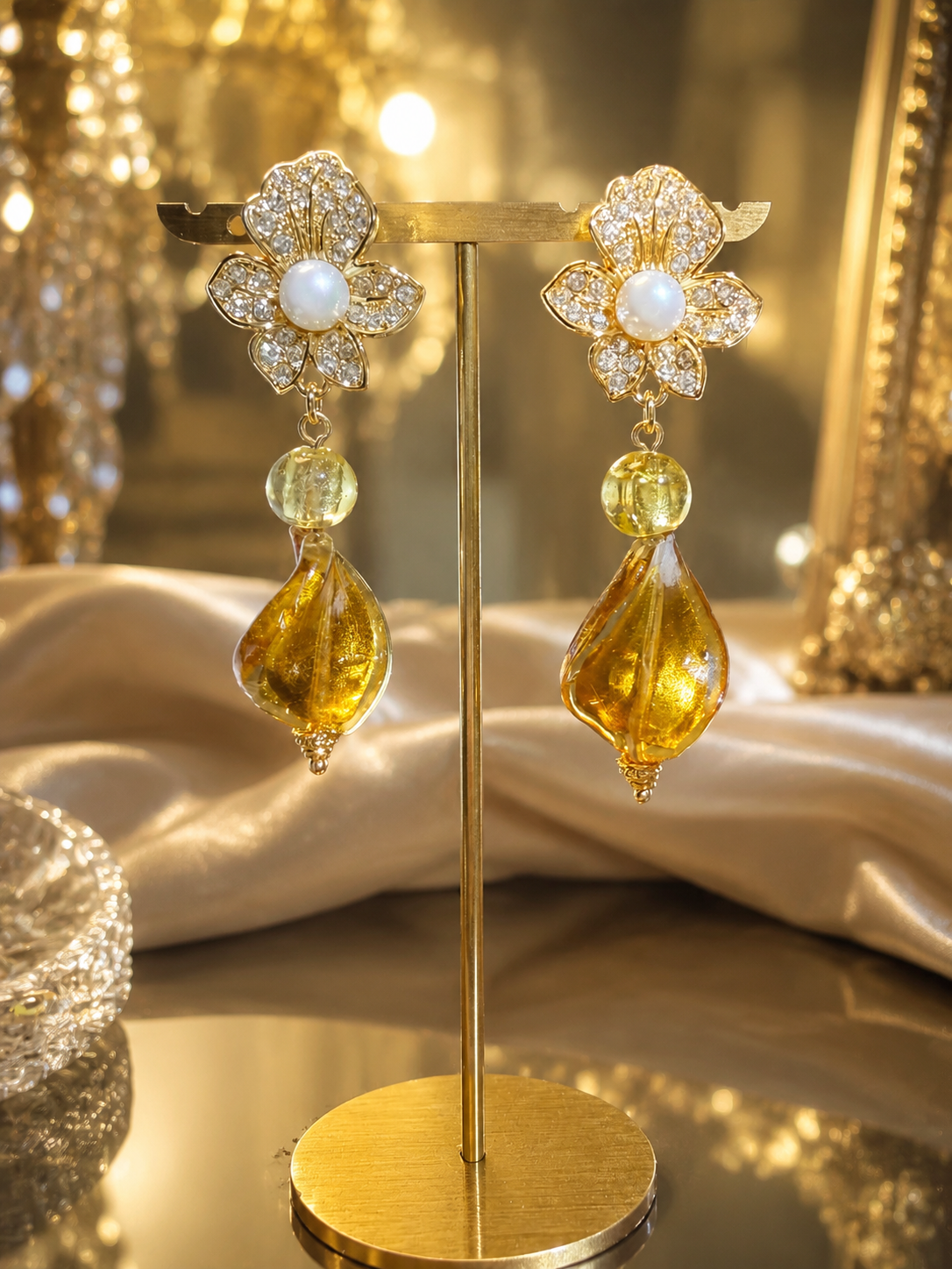 Gold-tone floral clip-on drop earrings with amber-tone accents side view