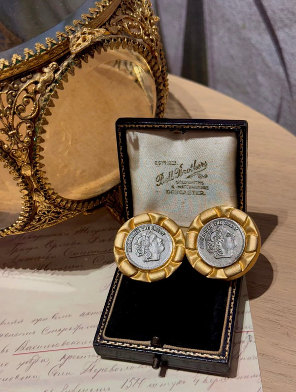 Gold-tone coin-style clip-on statement earrings with silver-tone medallion centers