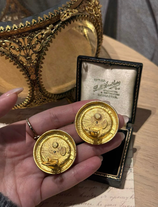 Back view of gold-tone coin-style clip-on earrings with clip closure