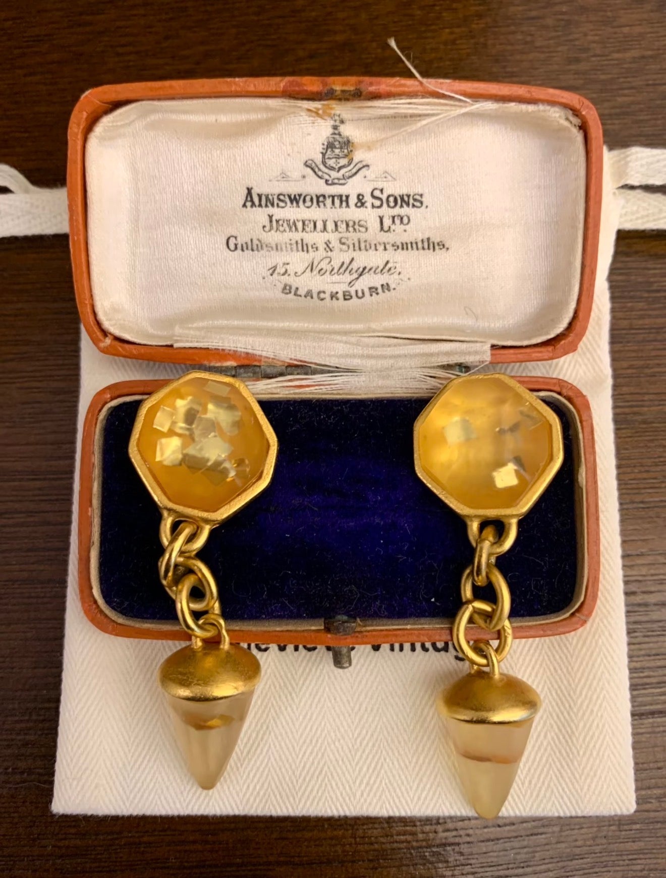 Gold-tone clip-on chain drop earrings with amber-tone accents