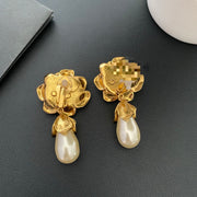 Reverse view of the floral earrings showing the clip-on fastenings and dangling drops