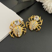 Pair of 18K gold-plated spider clip-on earrings with clear faceted stone accents