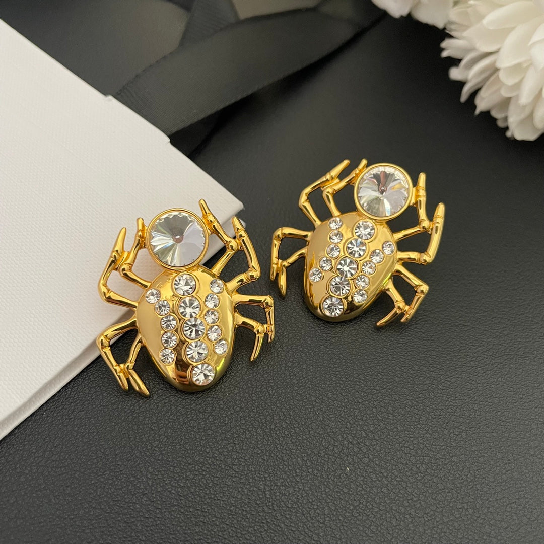 Pair of 18K gold-plated spider clip-on earrings with clear faceted stone accents