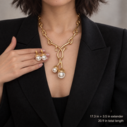Bamboo-link pearl-style pendant necklace worn with the matching stud earrings held alongside; image shows length and extender measurements