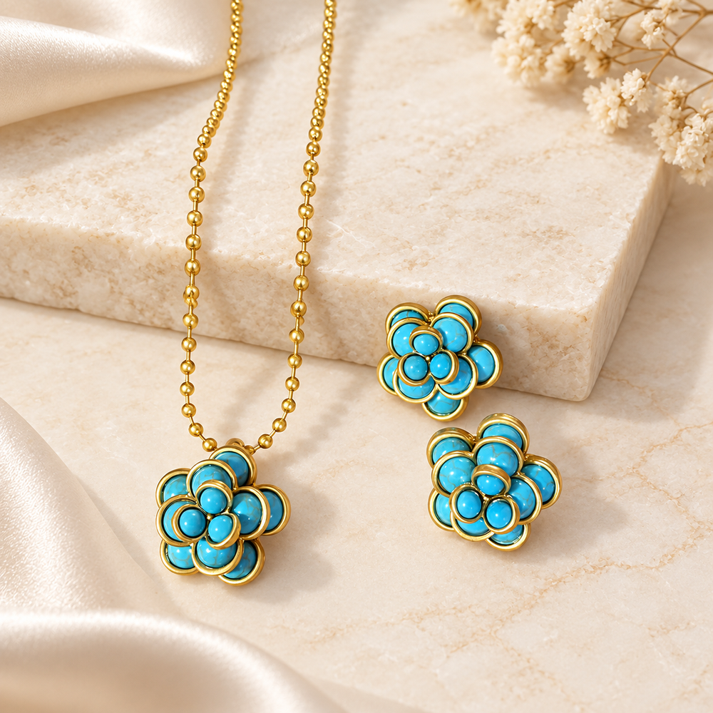 Gold-tone turquoise-blue flower pendant necklace with matching layered flower stud earrings