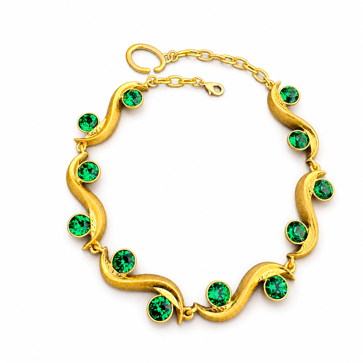Gold-tone sculptural wave bracelet with peacock green faceted crystal-style accents