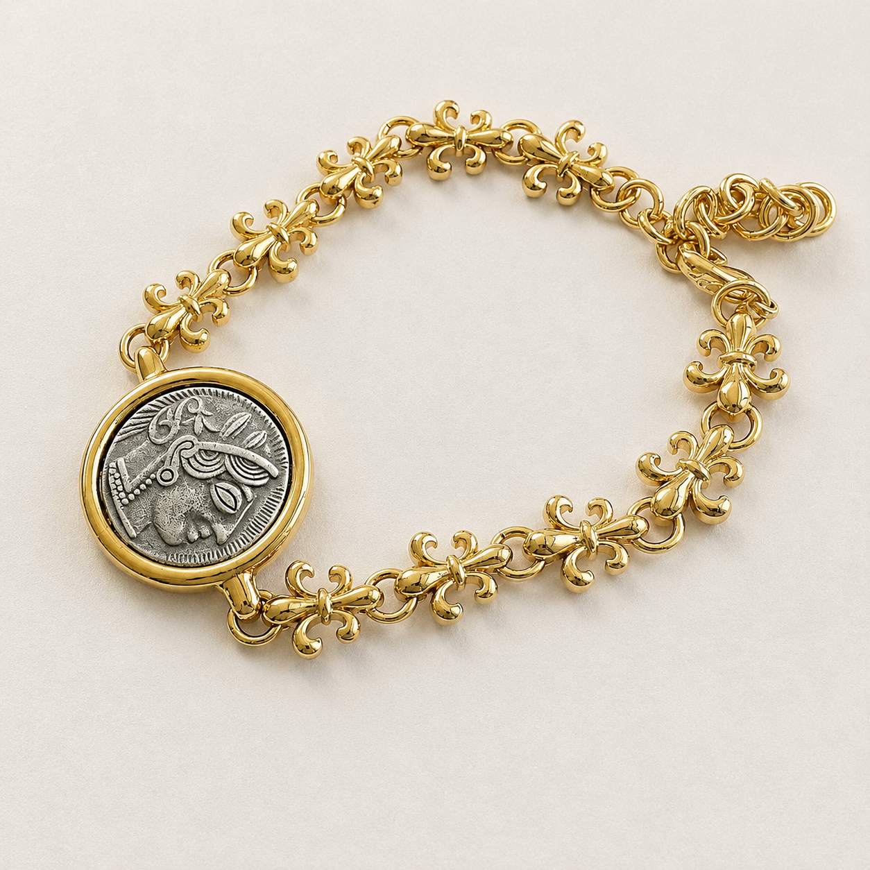 Detail view of the coin medallion and ornate floral bracelet links