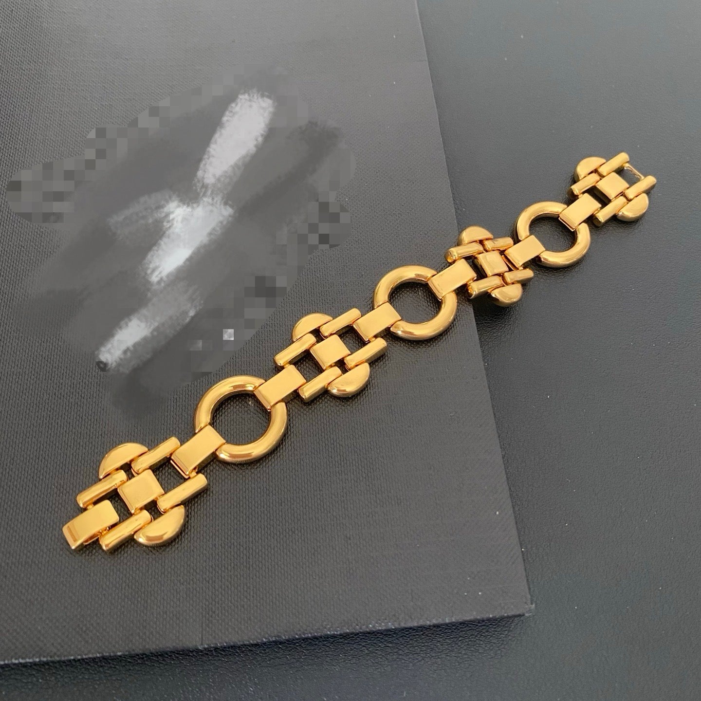 Full view of the gold-tone geometric link bracelet